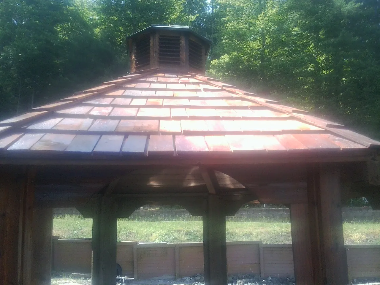 New cedar shake roof and cupola on a lakeside gazebo in Atkinson